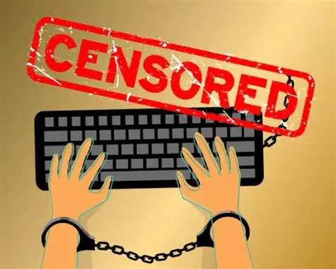Drawing of keyboard with two hands on the keys and handcuffs on their wrists. The word: Censored in red letters.